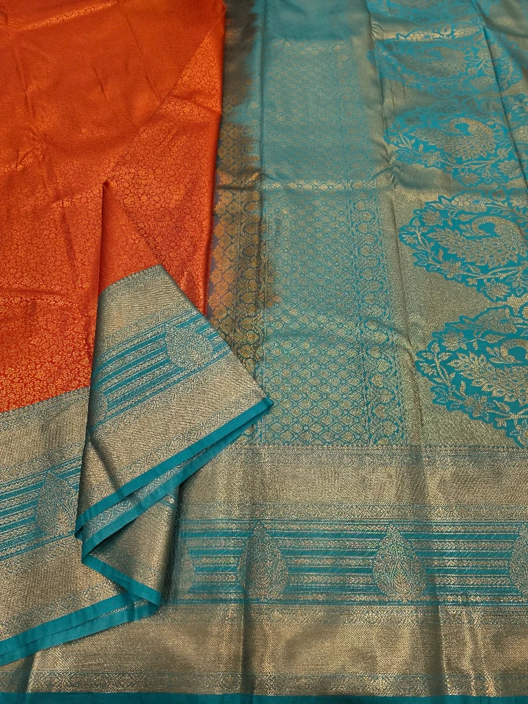 Burnt Orange Semi Kanchipuram Silk Saree with Peacock Blue Zari Border & Rich Gold Pallu