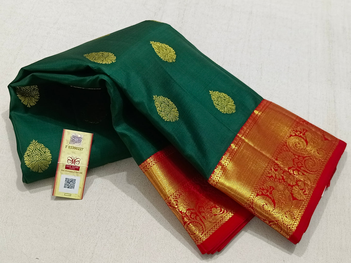 Traditional green kanchipuram silk saree with red border