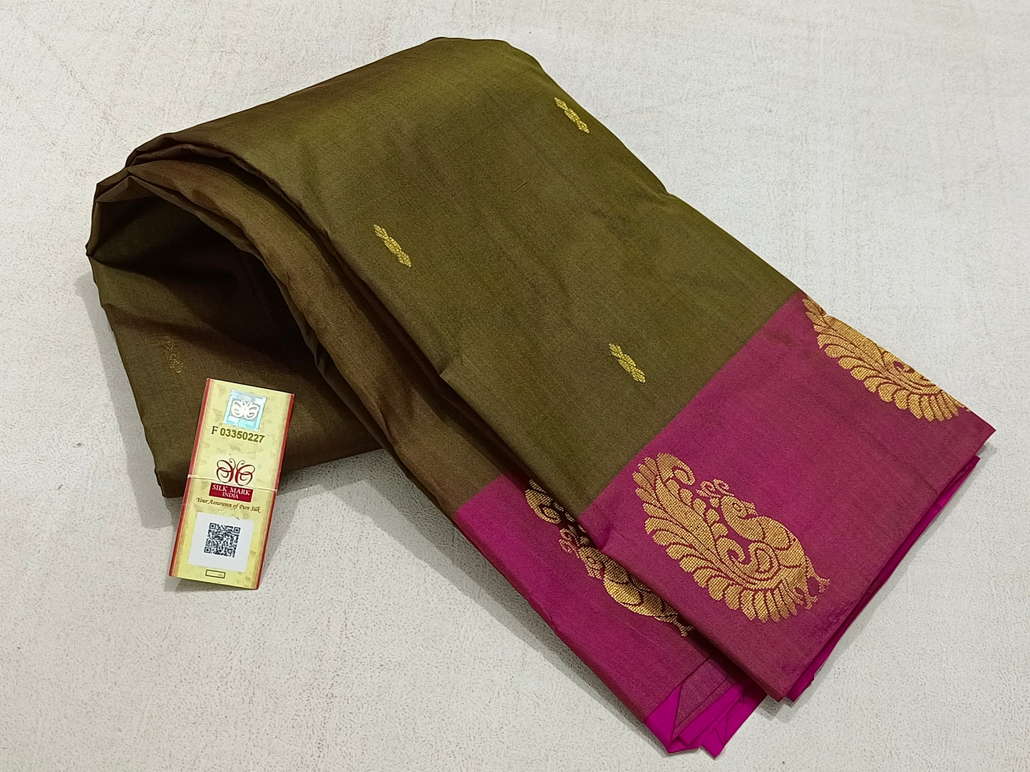 Traditional olive green kanchipuram silk saree with pink border