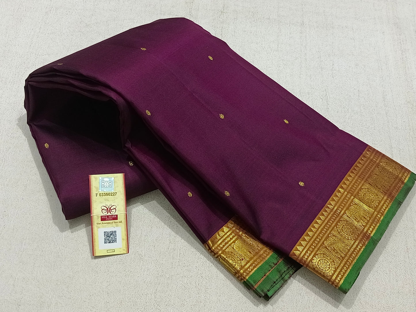 Traditional magenta kanchipuram silk saree with turmeric border