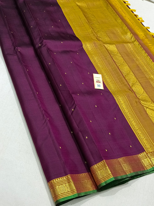 Traditional magenta kanchipuram silk saree with turmeric border