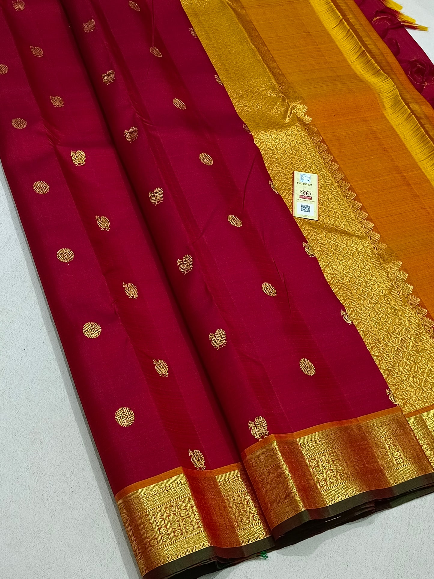 Traditional red kanchipuram silk saree with turmeric border