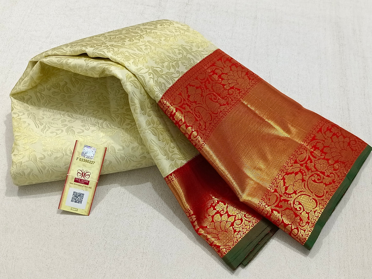 Traditional white kanchipuram silk saree with red border