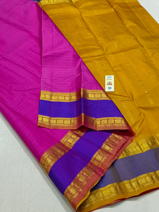 Traditional pink kanchipuram silk saree with blue border and turmeric pallu