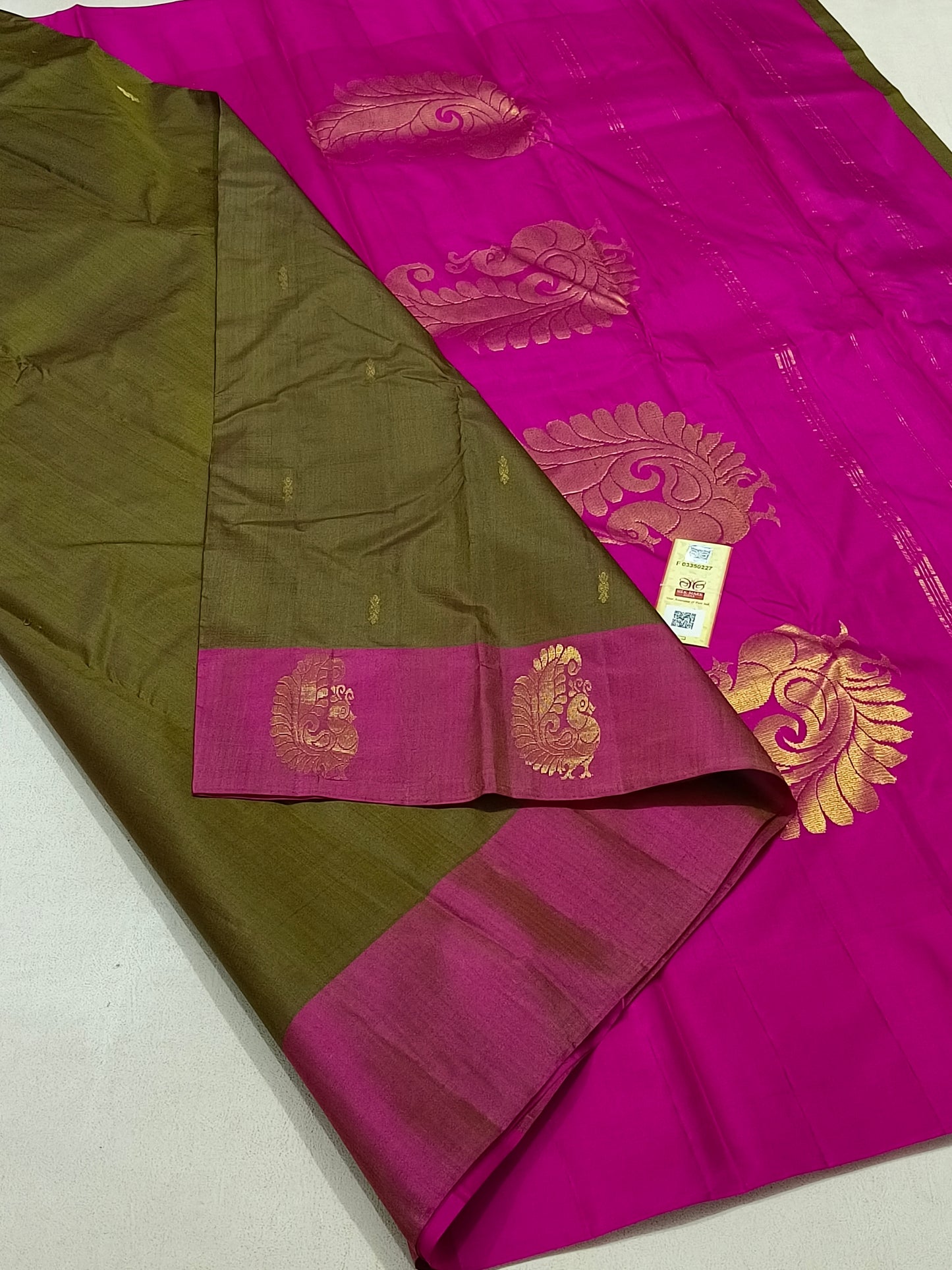 Traditional olive green kanchipuram silk saree with pink border