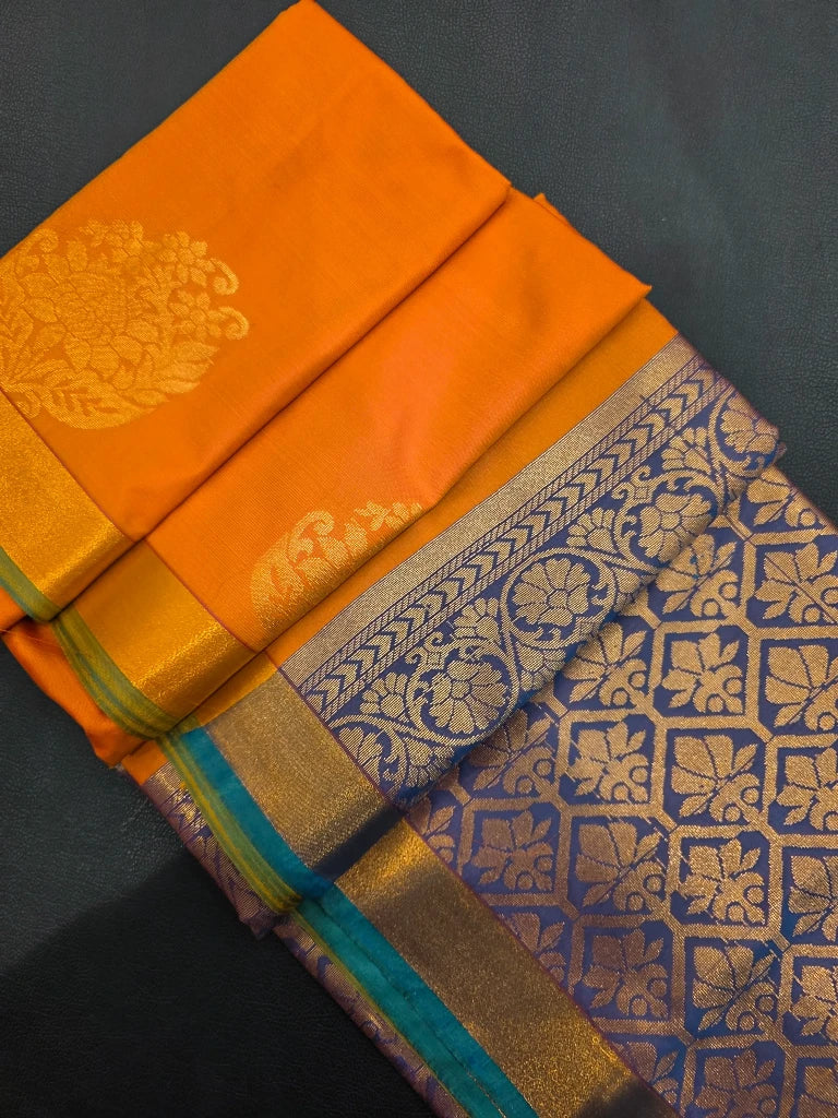 Orange Semi Kanchipuram Silk Saree with Gold Zari Floral Buttas & Royal Blue Brocade Pallu